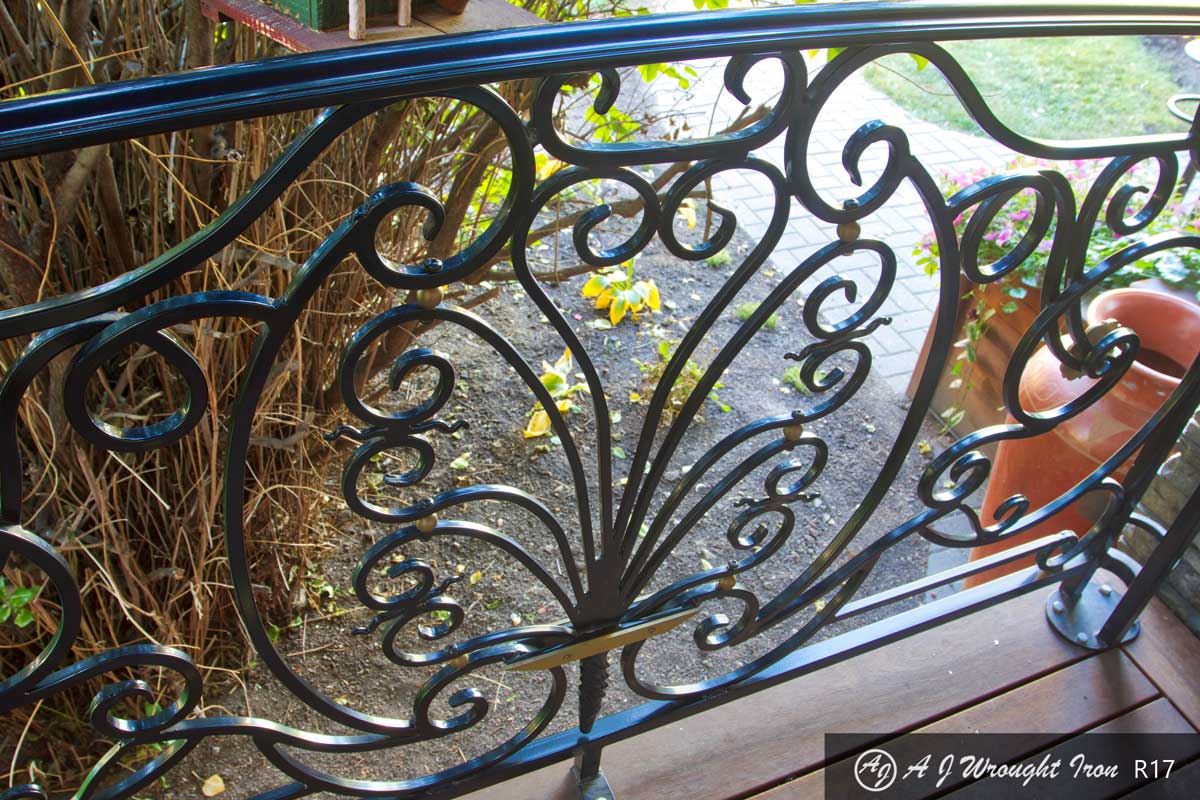 curved plant motif on metal railing