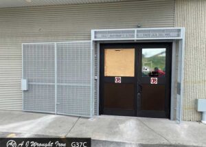 commercial bi-fold security gate on brick building