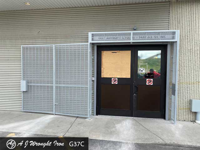 commercial bi-fold security gate on brick building