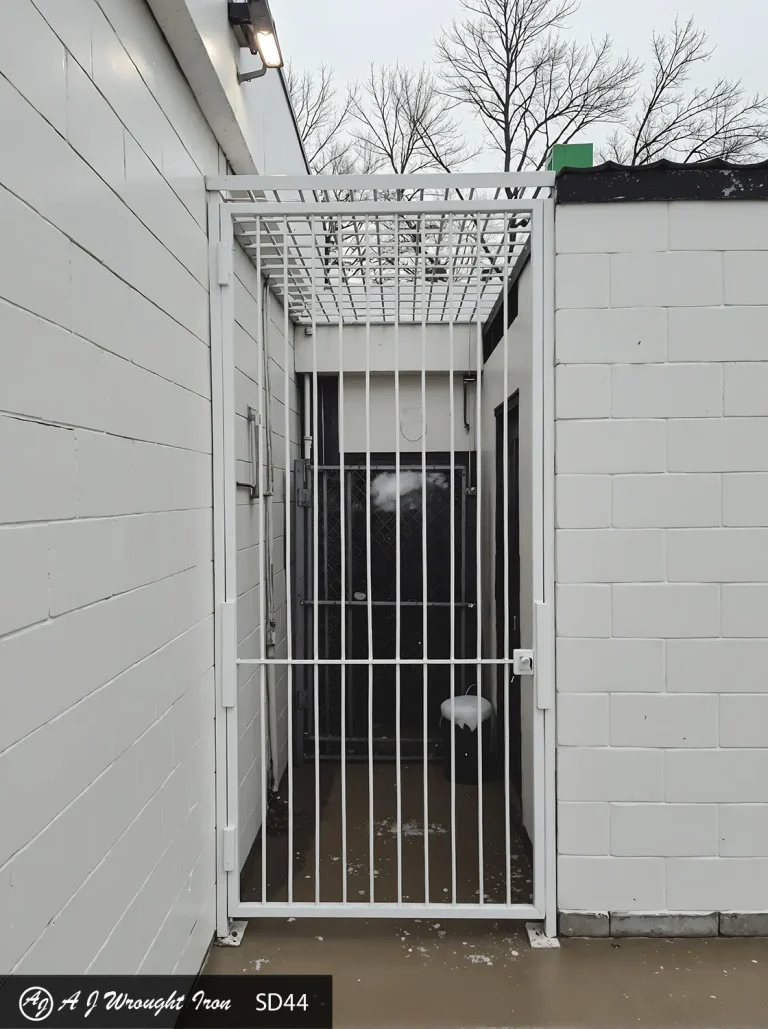 simple white wrought iron security gate and cage for business entrance