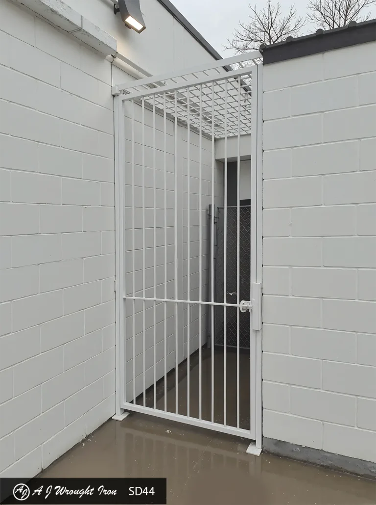 simple white wrought iron security gate and cage for business entrance